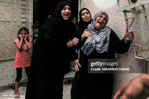 Palestinians and relatives mourn over the death of 15-year-old protester Othman Rami Halles during his funeral east of Gaza City on July 14, 2018. -...