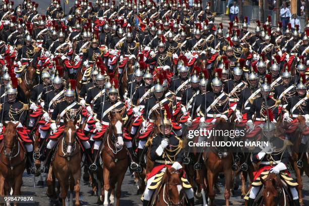 French Mounted Republican guards take part in the annual Bastille Day military parade on the Champs-Elysees avenue as the Arch of Triumph in Paris on...