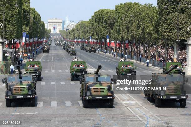 Members of the 3rd Marine Artillery Regiment and CAESAR truck-mounted 155 mm gun-howitzer, take part in the annual Bastille Day military parade on...