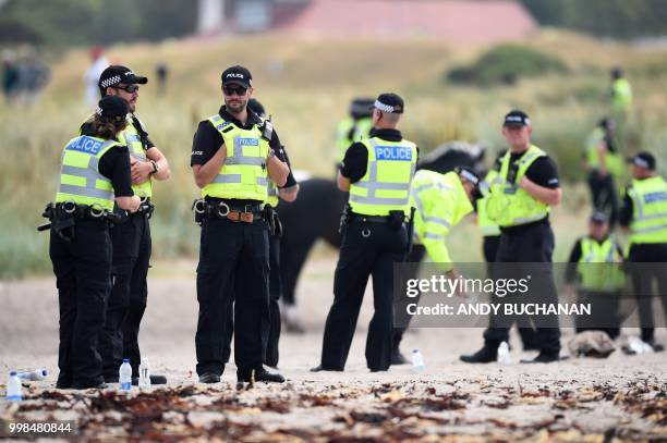 Police offficers stand guard outside Trump Turnberry, the luxury golf resort of US President Donald Trump, in Turnberry, southwest of Glasgow,...