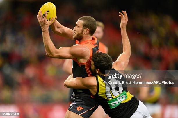 Sam Ried of the Giants is tackled by Shane Edwards of the Tigers during the round 17 AFL match between the Greater Western Sydney Giants and the...