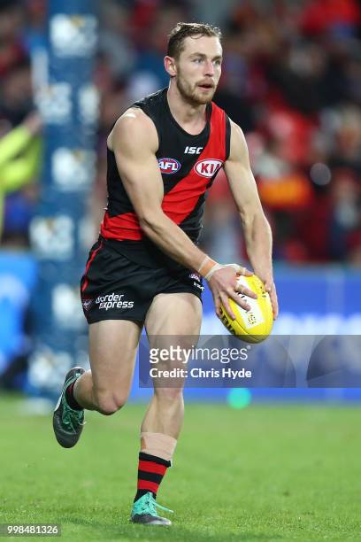 Devon Smith of the Bomers kicks during the round 17 AFL match between the Gold Coast Suns and the Essendon Bombers at Metricon Stadium on July 14,...