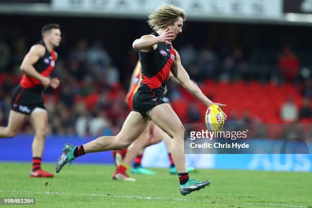 Dyson Heppell of the Bombers kicks during the round 17 AFL match between the Gold Coast Suns and the Essendon Bombers at Metricon Stadium on July 14,...