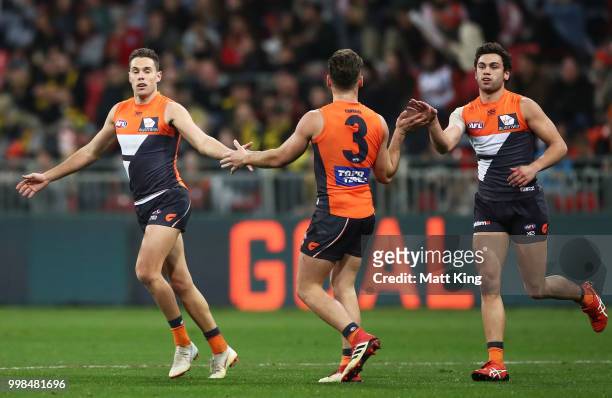 Josh Kelly of the Giants celebrates with team mates after kicking a goal during the round 17 AFL match between the Greater Western Sydney Giants and...