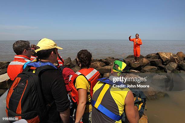 Greenpeace marine biologist Paul Horsman speaks to journalists from an oil covered jetti at the mouth of the Mississippi River on May 17, 2010 in...