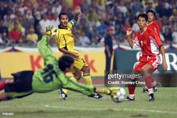 Hairuddin Omar of Malaysia saw his shot was saved by Nguyen The Anh Vietnam while Vu Nhu Thanh looks on during the Men's Under-23 Group A Match held...