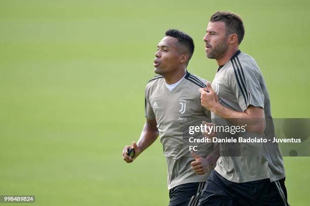 Alex Sandro and Andrea Barzagli during a Juventus morning training session on July 14, 2018 in Turin, Italy.