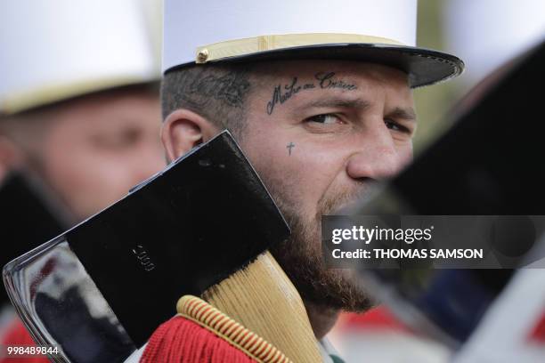 Member of the 2e Regiment Etranger d'Infanterie de la Legion Etrangere wears a tattoo with the legion's motto 'March or Die' (Marche ou Creve' as he...