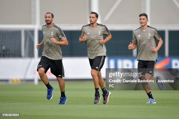 Giorgio Chiellini , Mattia De Sciglio and Mattia Caldara during a Juventus morning training session on July 14, 2018 in Turin, Italy.