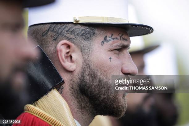 Member of the 2e Regiment Etranger d'Infanterie de la Legion Etrangere wears a tattoo with the legion's motto 'March or Die' (Marche ou Creve' as he...