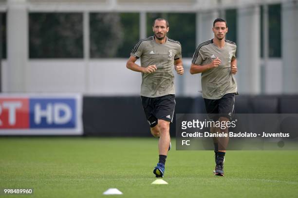 Giorgio Chiellini and Mattia De Sciglio during a Juventus morning training session on July 14, 2018 in Turin, Italy.