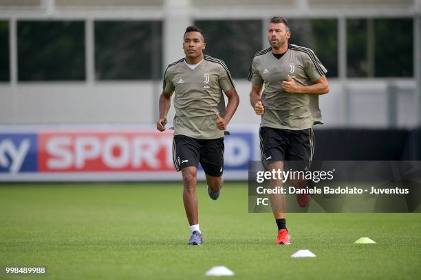 Alex Sandro and Andrea Barzagli during a Juventus morning training session on July 14, 2018 in Turin, Italy.