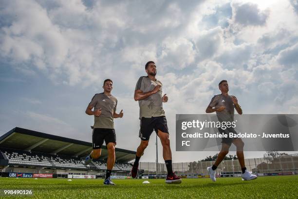 Mattia Caldara , Emre Can and Joao Cancelo during a Juventus morning training session on July 14, 2018 in Turin, Italy.