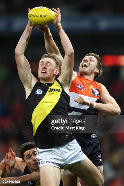 Callum Moore of the Tigers is challenged by Aidan Corr of the Giants during the round 17 AFL match between the Greater Western Sydney Giants and the...