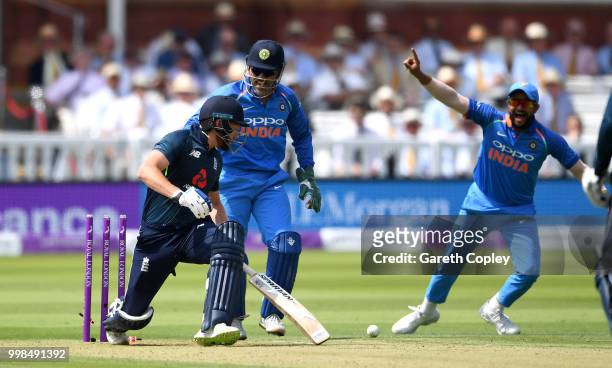 Dhoni and Suresh Raina of India celebrate as Jonathan Bairstow of England is bowled by Kuldeep Yadav during the 2nd ODI Royal London One-Day match...