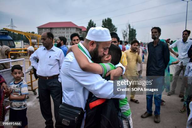 Kashmiri Muslim pilgrim hugs his son as he leaves for the annual hajj pilgrimage to the holy city of Mecca, in Srinagar, Indian administered Kashmir....