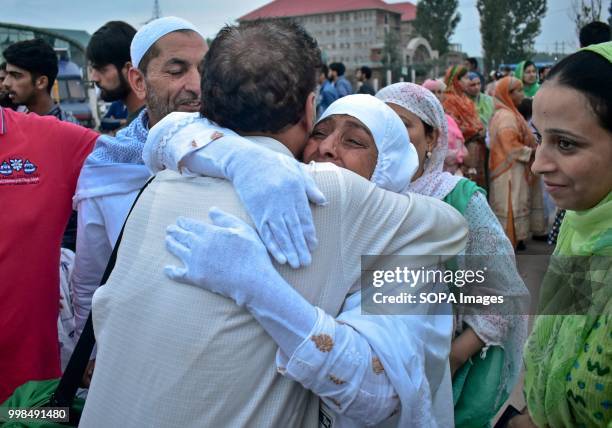 Kashmiri Muslim pilgrim is hugged by her relative as she leaves for the annual hajj pilgrimage to the holy city of Mecca, in Srinagar, Indian...
