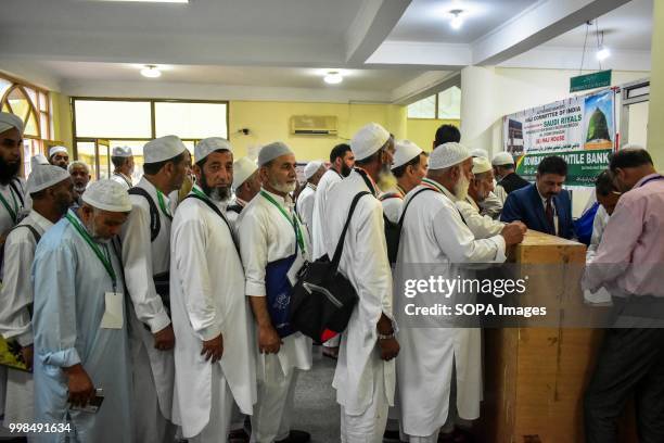 Kashmiri Muslim pilgrims stand in a queue to collect documents at hajj house in Srinagar, Indian administered Kashmir. The first batch of 820...