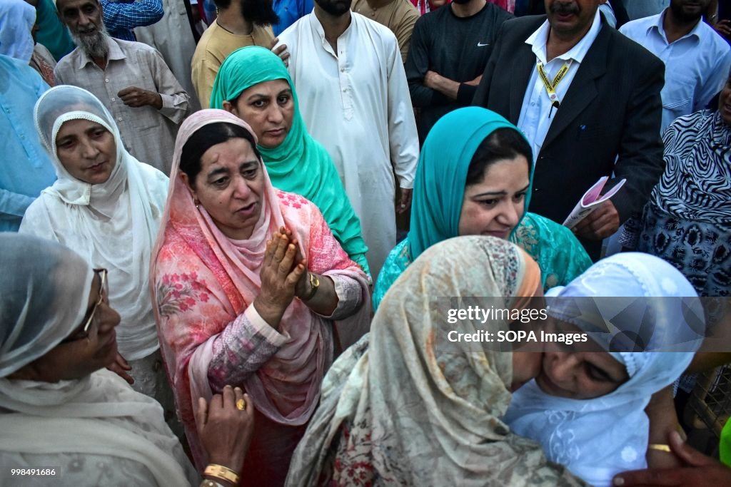 A relative of the Kashmiri Muslim pilgrim prays as she...