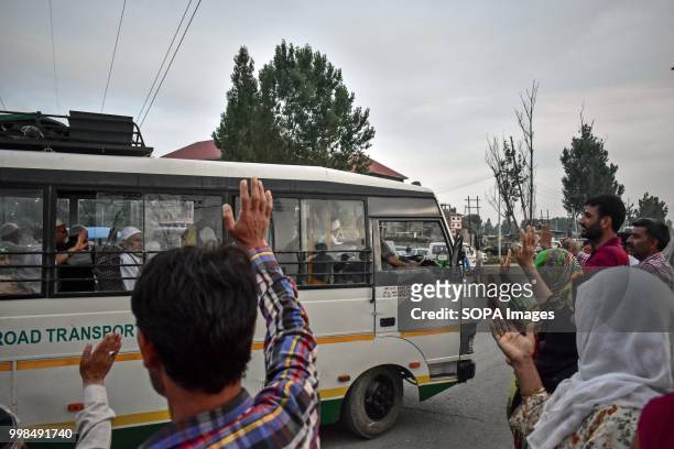 Kashmiri Muslim pilgrims wave to their relatives before leaving for the annual hajj pilgrimage to the holy city of Mecca, in Srinagar, Indian...