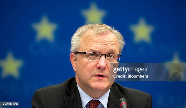 Olli Rehn, the European Union's economic and monetary affairs commissioner, speaks during a news conference following the meeting of European Union...