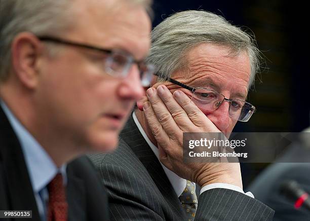 Jean-Claude Juncker, Luxembourg's prime minister and president of the Eurogroup, right, listens as Olli Rehn, the European Union's economic and...