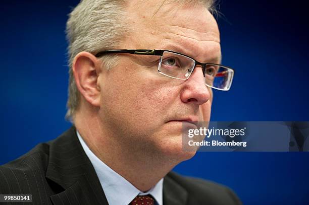 Olli Rehn, the EU's economic and monetary affairs commissioner, listens during a news conference following the meeting of European Union finance...