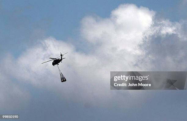 Louisiana National Guard blackhawk helicopter slingloads materials to fight the oil slick in the Gulf of Mexico on May 17, 2010 near Venice,...