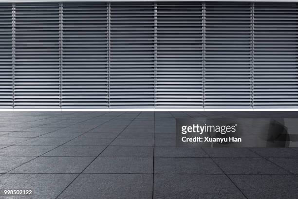 empty futuristic architecture with gray floors and silver metal line wall - facade blinds stock pictures, royalty-free photos & images