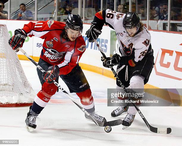 Marc Cantin of the Windsor Spitfires and Joel Broda of the Calgary Hitmen battle for the puck during the 2010 Mastercard Memorial Cup Tournament at...