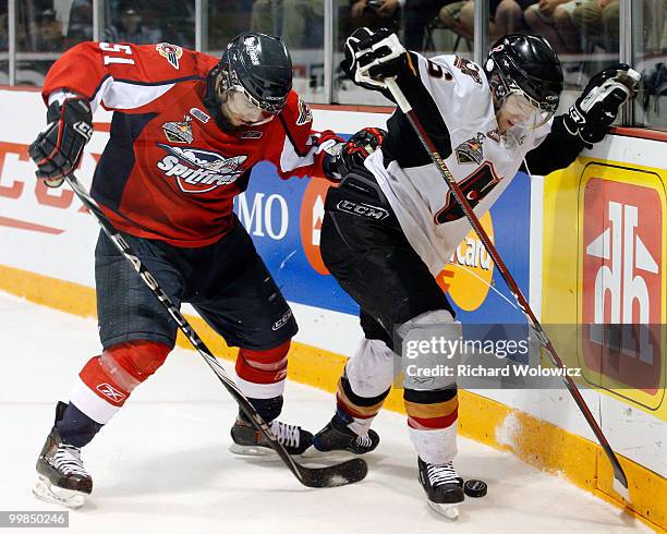 Mark Cundari of the Windsor Spitfires and Cody Sylvester of the Calgary Hitmen battle for the puck during the 2010 Mastercard Memorial Cup Tournament...