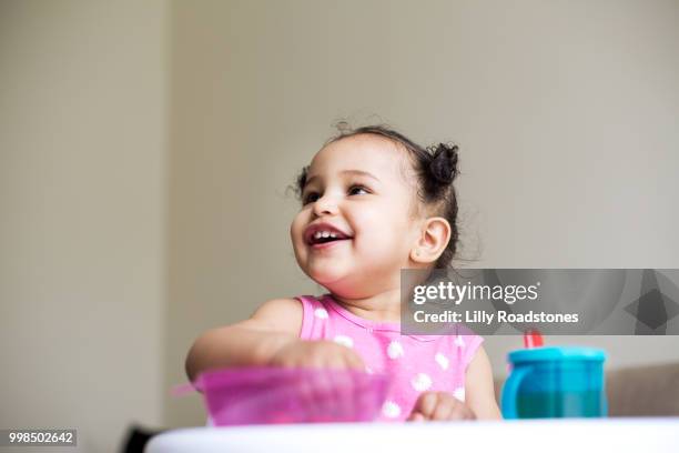 young child smiling while eating from bowl - laboratory glassware stock pictures, royalty-free photos & images