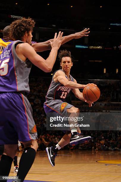 Steve Nash of the Phoenix Suns passes to teammate Robin Lopez during their game against the Los Angeles Lakers in Game One of the Western Conference...