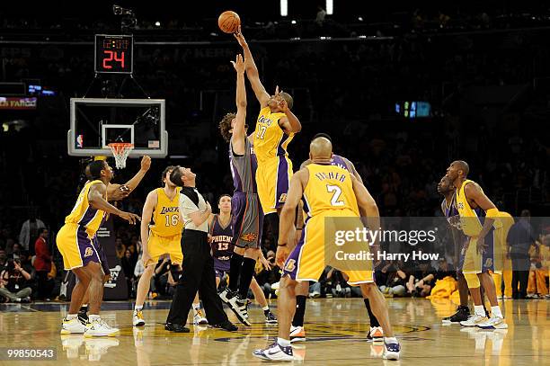 Center Andrew Bynum of the Los Angeles Lakers wins the opening tip off against center Robin Lopez of the Phoenix Suns in Game One of the Western...