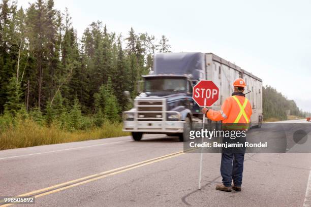 road construction flagman - benjamin rondel stock pictures, royalty-free photos & images