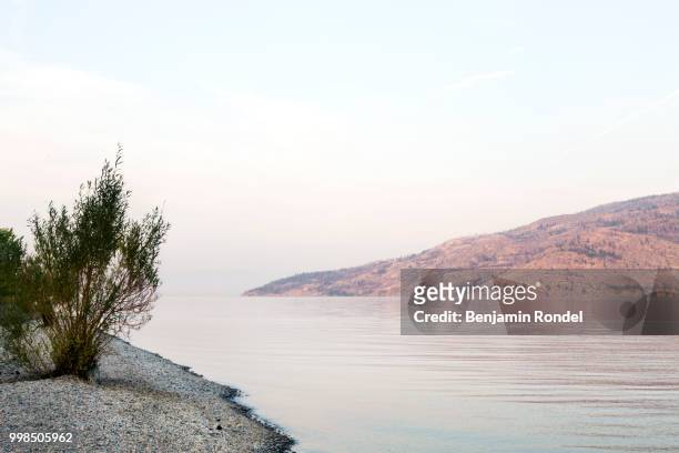 lake surrounded by mountains - benjamin rondel stock pictures, royalty-free photos & images