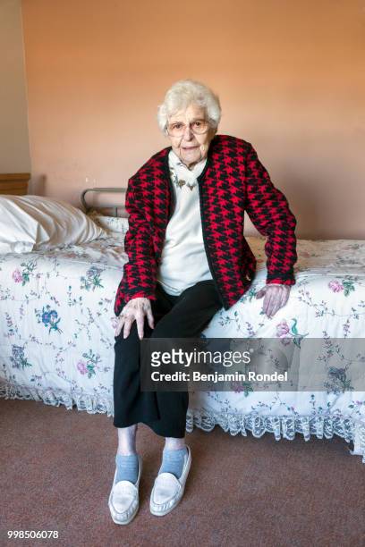 senior woman sitting on bed - benjamin rondel stock pictures, royalty-free photos & images