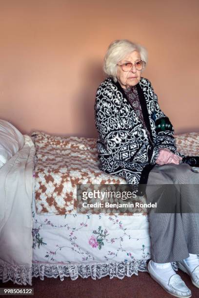 senior woman sitting on bed - benjamin rondel stock pictures, royalty-free photos & images