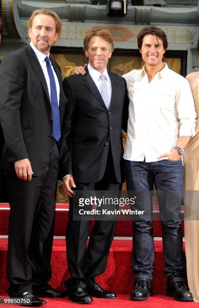 Actor Nicolas Cage, producer Jerry Bruckheimer and actor Tom Cruise pose during the Jerry Bruckheimer hand and footprint ceremony held at Grauman's...