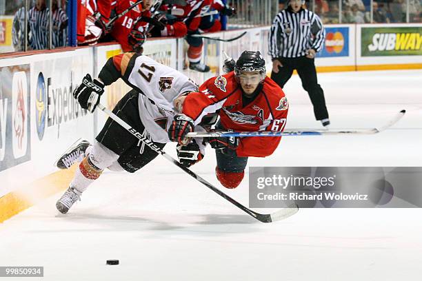 Eric Wellwood of the Windsor Spitfires body checks Giffen Nyren of the Calgary Hitmen during the 2010 Mastercard Memorial Cup Tournament at the...