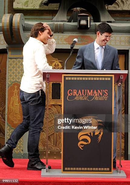 Actor Tom Cruise and Chairman of The Walt Disney Studios Rich Ross speak onstage during the Jerry Bruckheimer hand and footprint ceremony held at...