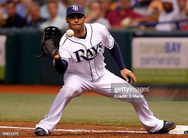 Infielder Carlos Pena of the Tampa Bay Rays takes the throw at first base against the Cleveland Indians during the game at Tropicana Field on May 17,...
