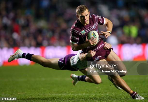 Tom Trbojevic of the Sea Eagles is tackled during the round 18 NRL match between the Manly Sea Eagles and the Melbourne Storm at Lottoland on July...