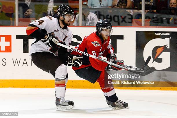 Ryan Ellis of the Windsor Spitfires defends against Del Cowan of the Calgary Hitmen during the 2010 Mastercard Memorial Cup Tournament at the...
