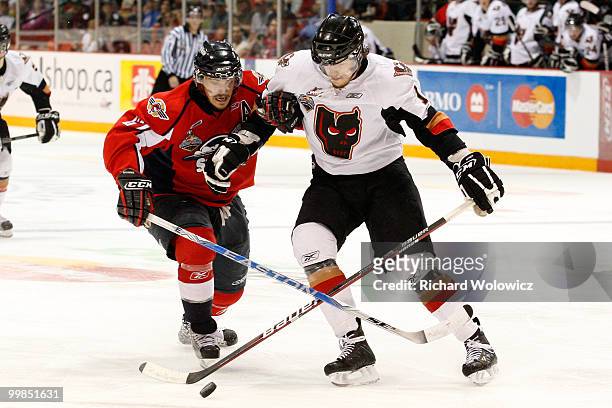 Eric Wellwood of the Windsor Spitfires and Michael Snider of the Calgary Hitmen battle for the puck during the 2010 Mastercard Memorial Cup...