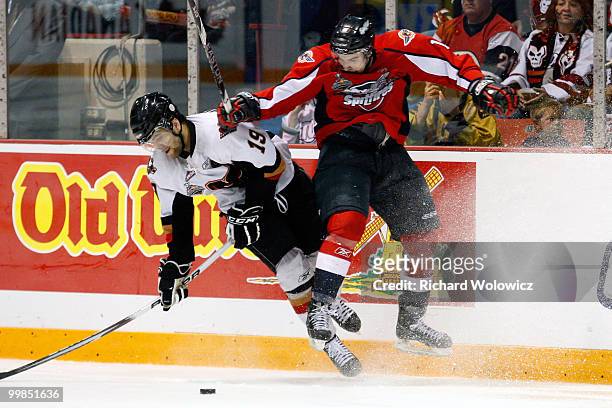 Marc Cantin of the Windsor Spitfires body checks Ian Schultz of the Calgary Hitmen during the 2010 Mastercard Memorial Cup Tournament at the Keystone...