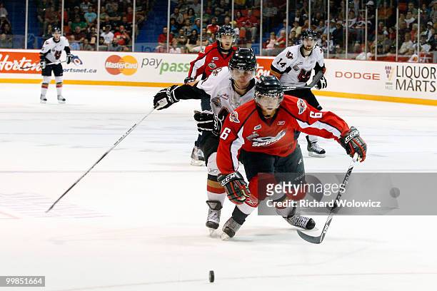 Ryan Ellis of the Windsor Spitfires and Kris Foucault of the Calgary Hitmen chase the puck into the corner during the 2010 Mastercard Memorial Cup...