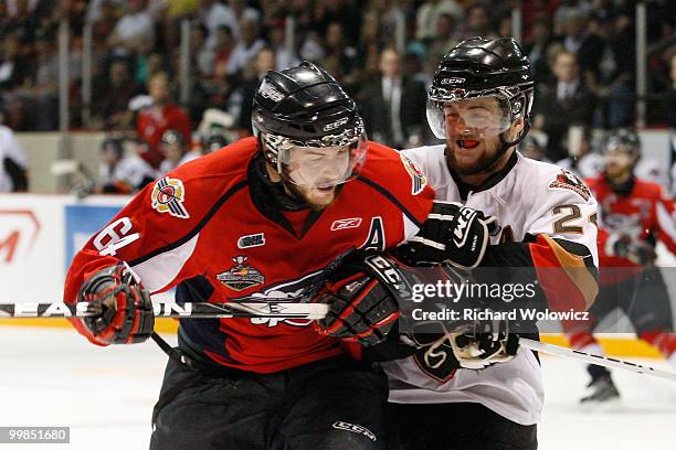 Del Cowan of the Calgary Hitmen body checks Greg Nemisz of the Windsor Spitfires during the 2010 Mastercard Memorial Cup Tournament at the Keystone...