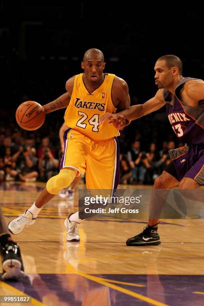 Guard Kobe Bryant of the Los Angeles Lakers drives with the ball against the Phoenix Suns in Game One of the Western Conference Finals during the...