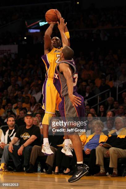 Guard Kobe Bryant of the Los Angeles Lakers takes a shot against Grant Hill of the Phoenix Suns in Game One of the Western Conference Finals during...